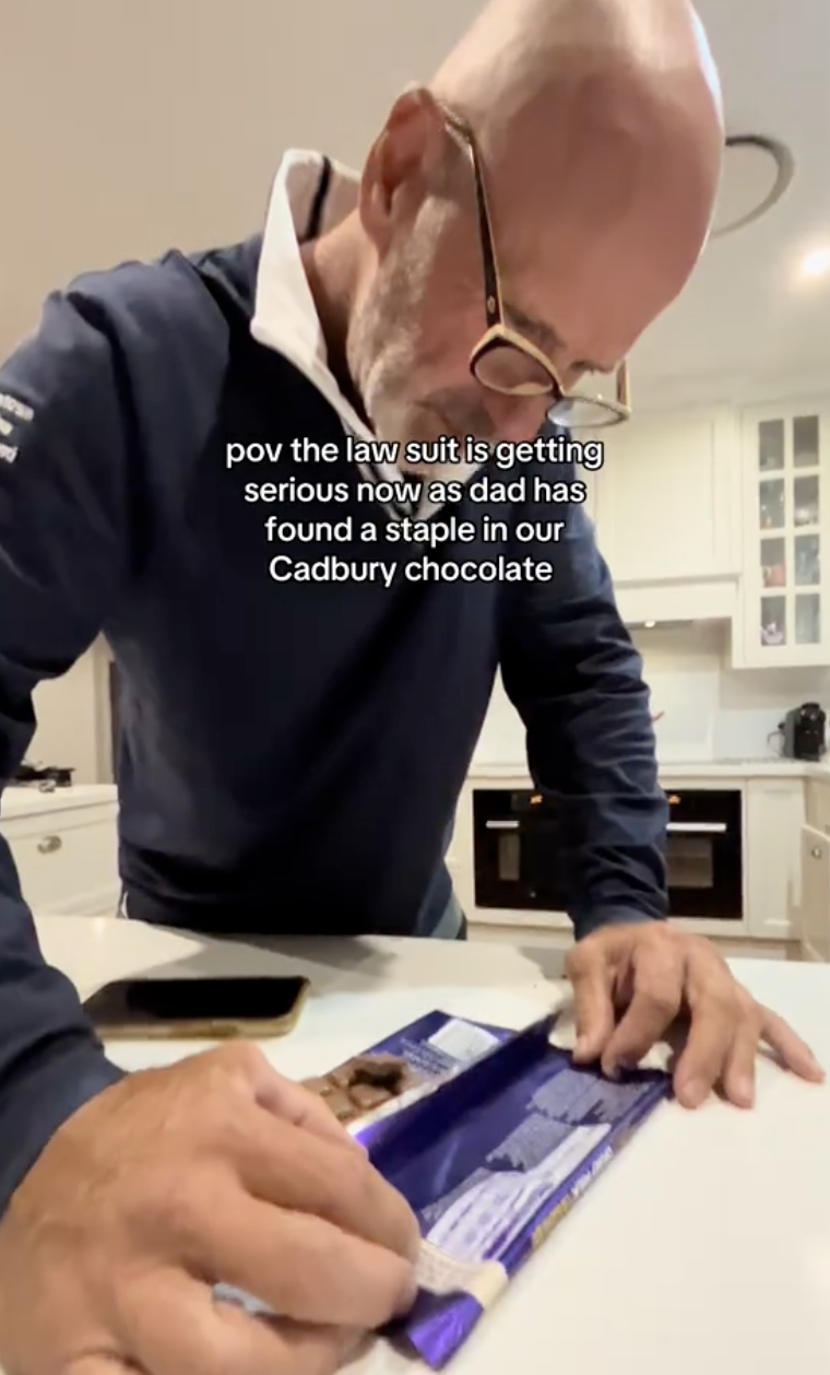 man opening bar of chocolate